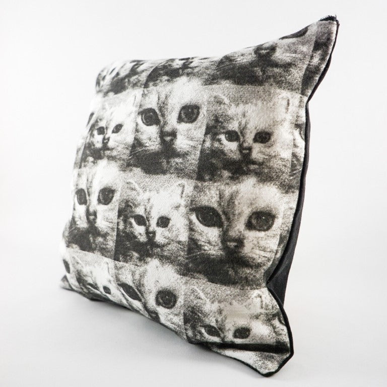 On the front of the pillow cover is a mosaic of cute kittens face in black and white. While the back of the pillow cover is a solid black colour. A line of zipper is available at the top of the pillow.