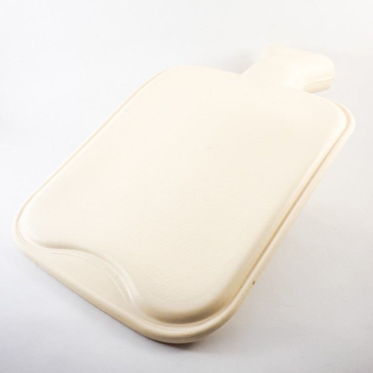 A white hot water bottle made out of hight density rubber placed inside the soft pink flannel, can be taken out completely from the cover.