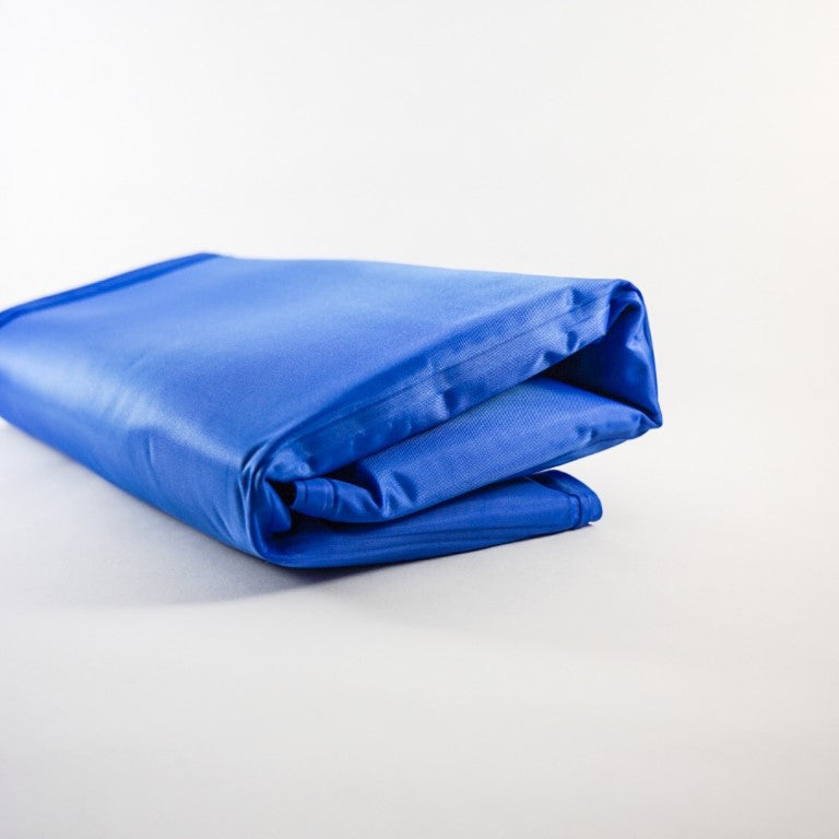 A medium size pet cooling mat in blue colour, for cats and dogs, can be fold to keep it compact for traveling.